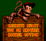 A message of a new option unlocked in Donkey Kong Country for GBC. After completing the game once at certain rate percentage, this unlocked option allows to desactivate Star Barrels and/or DK Barrels in the Adventure mode, and play a harder mode of the main game.