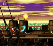 Diddy about to defeat a Kruncha with a Treasure Chest in Donkey Kong Country 2 for SNES.