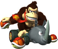 Artwork of Donkey Kong piloting the Rambi Rider, from the game Mario Kart DS for DS.