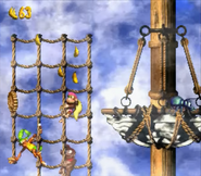 Dixie and Diddy Kong climbing up on some knotted ropes next to a Klinger, as seen in the game Donkey Kong Country 2: Diddy's Kong Quest for SNES. These square-like webs of ropes allow the primates to climb vertical or horizontally.