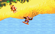 DK sits in a chair on the island, while Funky catches some waves in the Donkey Kong Country 2 remake.