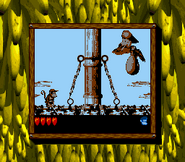 Krow about to drop a bouncing egg in the game Donkey Kong Land 2 for Game Boy, as seen on the Super Game Boy for SNES.