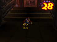 Lanky Kong being tracked down by Kroc's cursor before the enemy shooting at the Kong at the end of a time counter, as seen in the level Angry Aztec of the game Donkey Kong 64 for Nintendo 64.