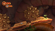 In multiplayer mode, Donkey and Diddy Kong avoiding two large spiky boulders by crouching inside small alcoves (Wii version).