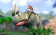 Diddy Kong riding a giant Rambi on some jungle setting.