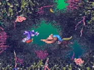 Purple Nibbla about to eat a red Koco.