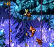 Donkey and Diddy Kong jumping between slippery ropes inside the stage Slipslide Ride, as seen in the game Donkey Kong Country for SNES. The blue ropes make the Kongs to slip upwards, and the red ones to slip downwards.