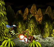 Queen B. hit by a barrel, as seen in the game Donkey Kong Country for SFC/SNES.