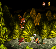 Donkey Kong jumping towards Very Gnawty, as seen in the game Donkey Kong Country for SFC/SNES.