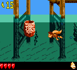 Dixie Kong approaching a Bonus Barrel underwater, as seen in the game Donkey Kong GB: Dinky Kong & Dixie Kong for GBC.