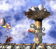 Dixie Kong about to throw an egg at Krow as seen in the game Donkey Kong Country 2: Diddy's Kong Quest for SNES.