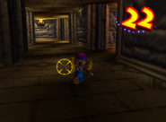 Tiny Kong running to evade Kroc's yellow cursor within a time limit, as seen in the level Angry Aztec of the game Donkey Kong 64 for Nintendo 64.