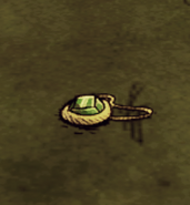 A Construction Amulet dropped on the ground.