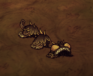 A complete Lucky Beast Costume lying on the ground.