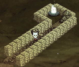 A protected cave entrance with lighting and traps