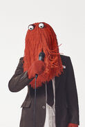 Red Guy in a suit with a microphone, for the interview with It's Nice That