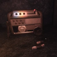 A generator with all 3 fuses on the ground before it.