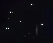 The glowing eyes of multiple Gloombats in the dark.