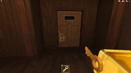 A player holding the Backdoor Room Key.