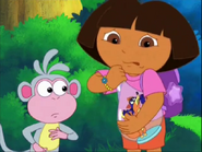 Dora struggles to open the bottle...