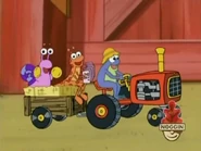 Look! The frog drives the tractor and the grasshopper and snail are in the back seat!
