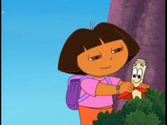 Dora puts it on him…