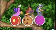 The Fiesta Trio on random round things! The snail is on a yo-yo, the grasshopper is on a cookie, and the frog is on a purple ball.