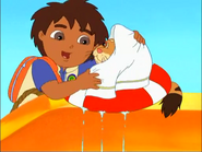 He dries him off with a towel.