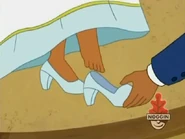 Her father puts her shoes on.