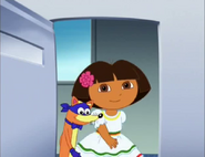 [Dora has a party dress and a flower for her hair]