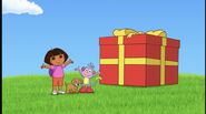 Help Dora and Boots open the present by saying the magic words, "¡Abrete, sorpresa!" which is Spanish for "Open, surprise!"