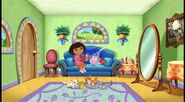 [This special episode begins with Dora and Boots relaxing on the couch reading a book. And look! There are the cats of her abuela!]