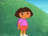 [¡Hola, Dora! The episode starts with her standing on a path.]