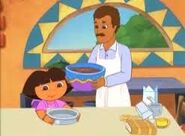 Dora baking a cake with her Papi