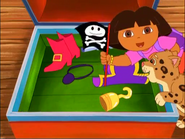 She waves it. (And perhaps there is one more thing that's in the treasure chest: A light blue pirate coat for Dora!)