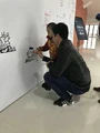 Fans drawing on a mural