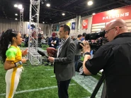 Liza getting interviewed on the set of Double Dare at Super Bowl