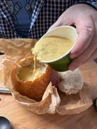 Pouring Broccoli Cheddar into the Bread Bowl