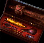 A small box with one side containing a statuette of Andraste, and the other side containing various paraphernalia: including small vials of lyrium, a spoon, a curved blade, a scalpel, a small waterskin with a dropper tip, and a grinder.