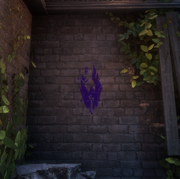 A purple mark found on a wall that resembles a crow.