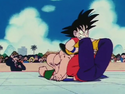 Goku grabs Tien's legs to make him give up