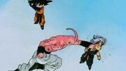 Buu punching Trunks, who was trying to fuse with Goten