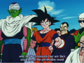 A man who resembles Tao, standing right behind Goku