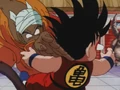 Nam slashes Goku in his neck