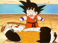 The Masked Man grabs Goku's tail