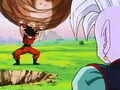 Goku lifts a big rock