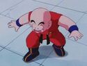 Krillin walks under Goku's weighted boots