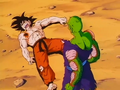 Piccolo stands over Goku after breaking his leg