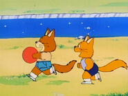 A couple children fox playing with a ball
