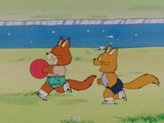 A couple children fox playing with a ball